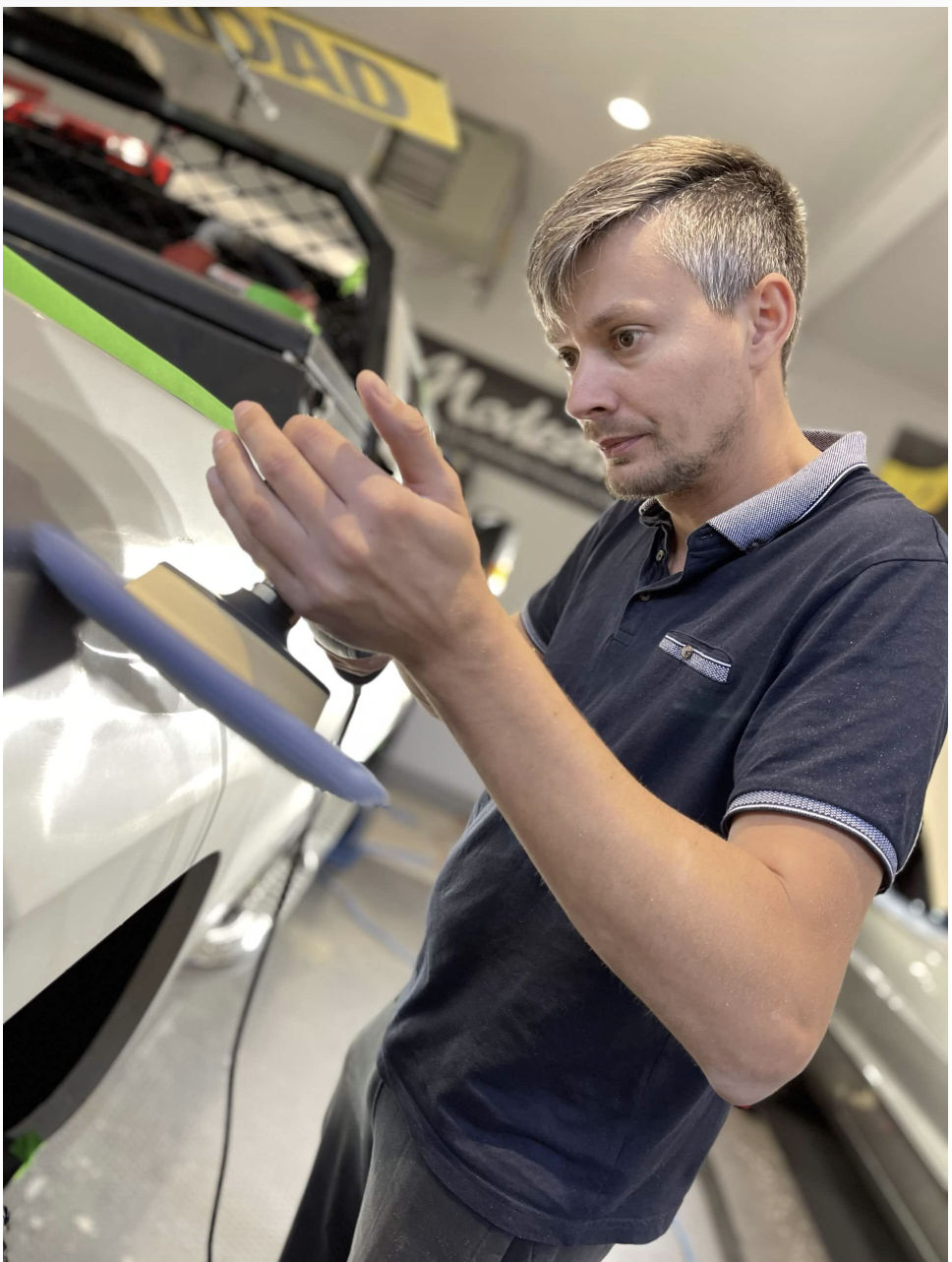 JH Auto Care detailer polishing a vehicle during a paint correction service